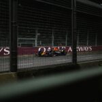 A race car is driving on the track.